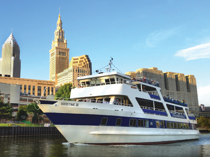 Corporate Events goodtimeiii boat, cruising down the river, with the city in the background