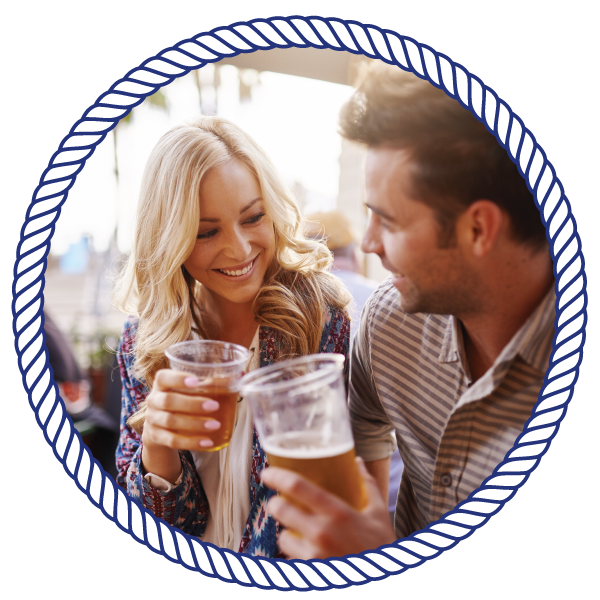 man and woman, smiling at eachother, with drinks in their hands