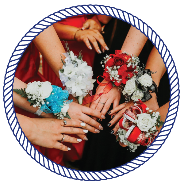 Proms bridesmaids, holding their hands close to each other, with flowers attached
