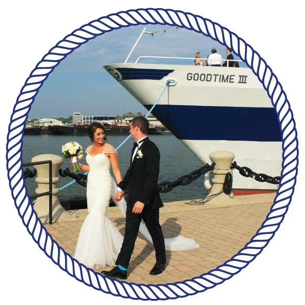 Weddings bride and groom, walking down a pier, with the goodtimeiii boat in the background