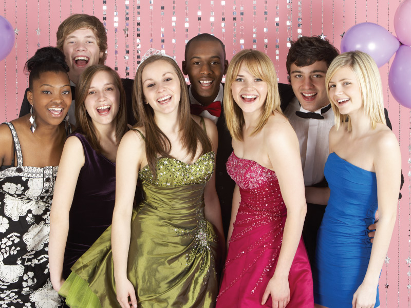 Prom - Feature Image group of teenage students, dressed for prom, smiling towards the camera